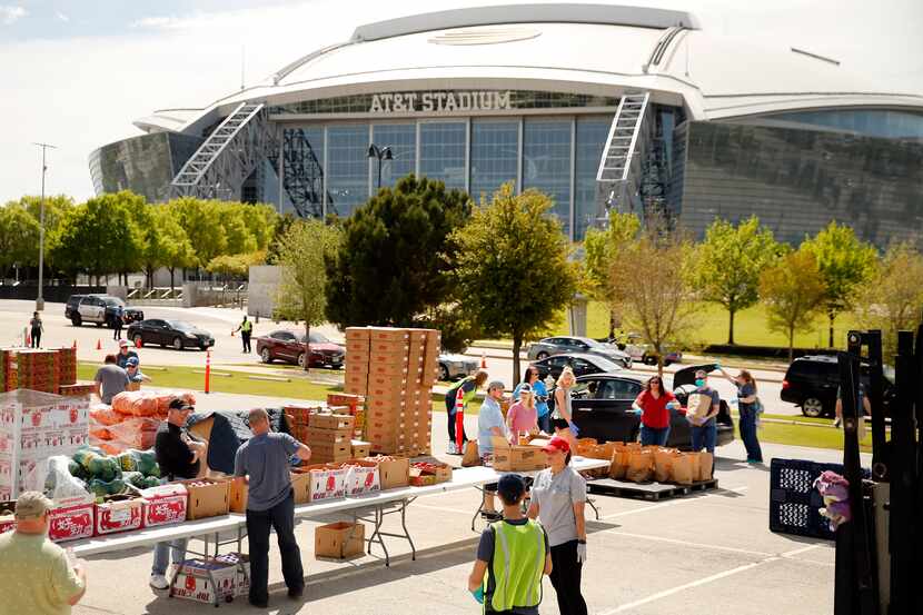 Tarrant Area Food Bank volunteers loaded vehicles with meals for Arlington ISD families...