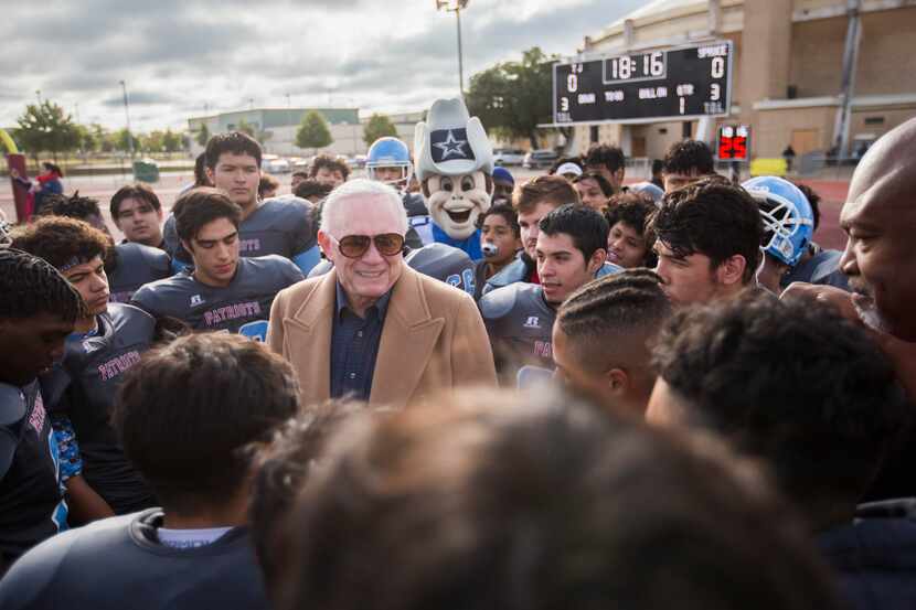 El dueño de los Cowboys, Jerry Jones, rodeado por jugadores de futbol americano de la...