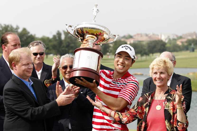 Sang-Moon Bae hoists the trophy up after winning in the final round of the Byron Nelson...
