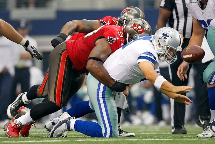 Dallas Cowboys quarterback Tony Romo (9) fumbles the ball in the third quarter as Tampa Bay...