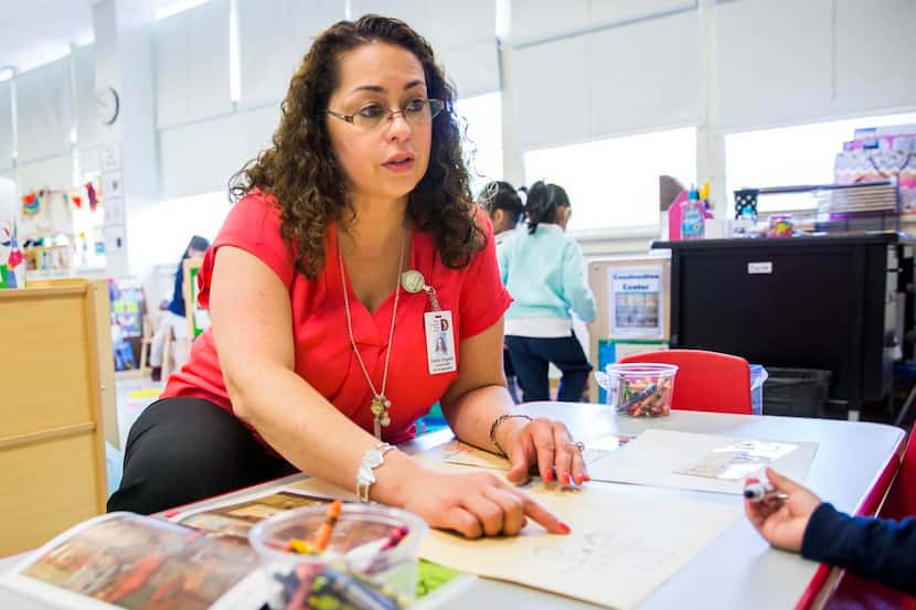 
Pre-K Specialist Yvette Delgado works with prekindergarten students on Thursday at Gill...