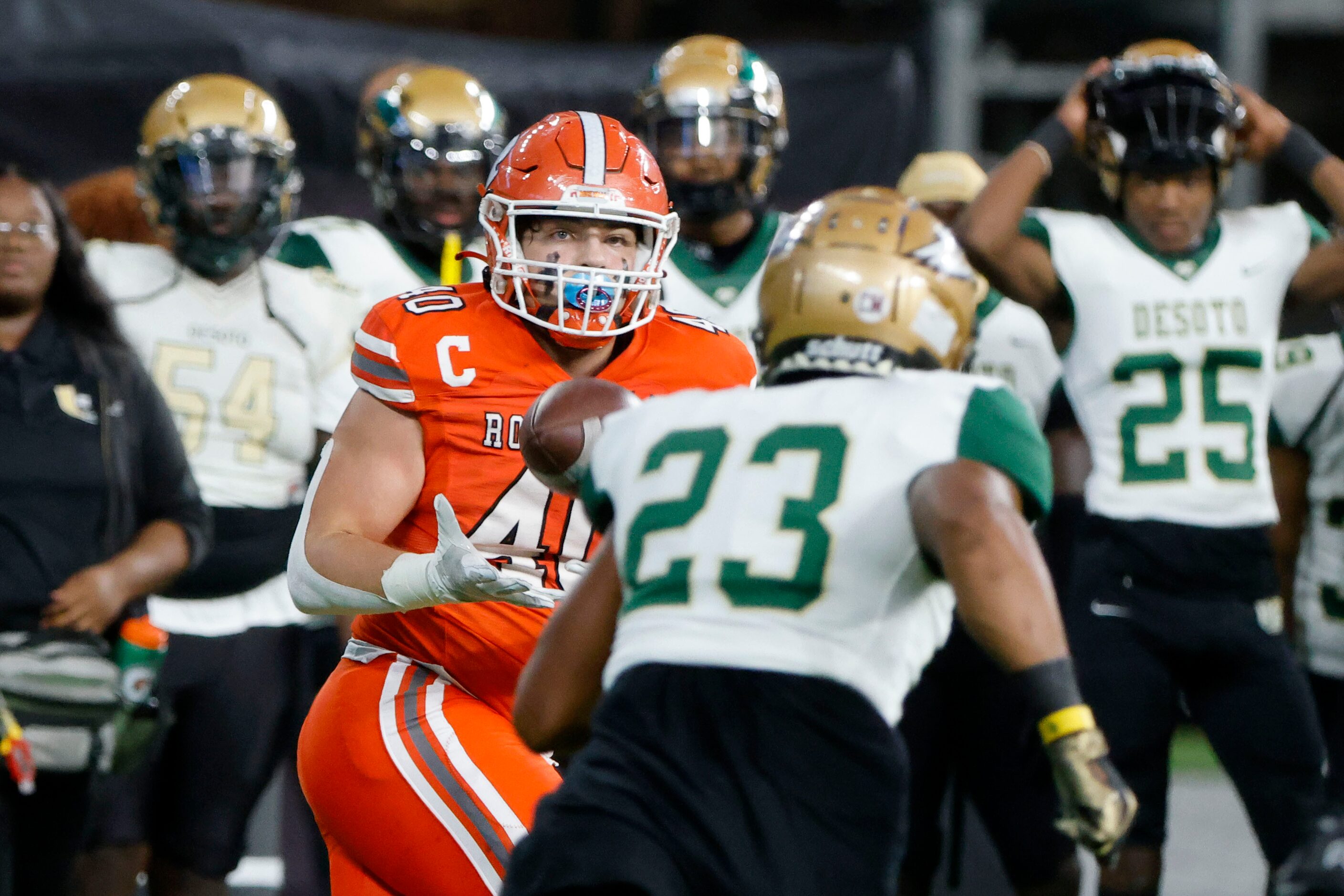 Rockwall tight end Brennan Ray (40) catches a pass as DeSoto’s London Maston (23) pursues...