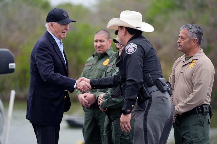 President Joe Biden talks with U.S. Border Patrol and local officials as he looks over the...