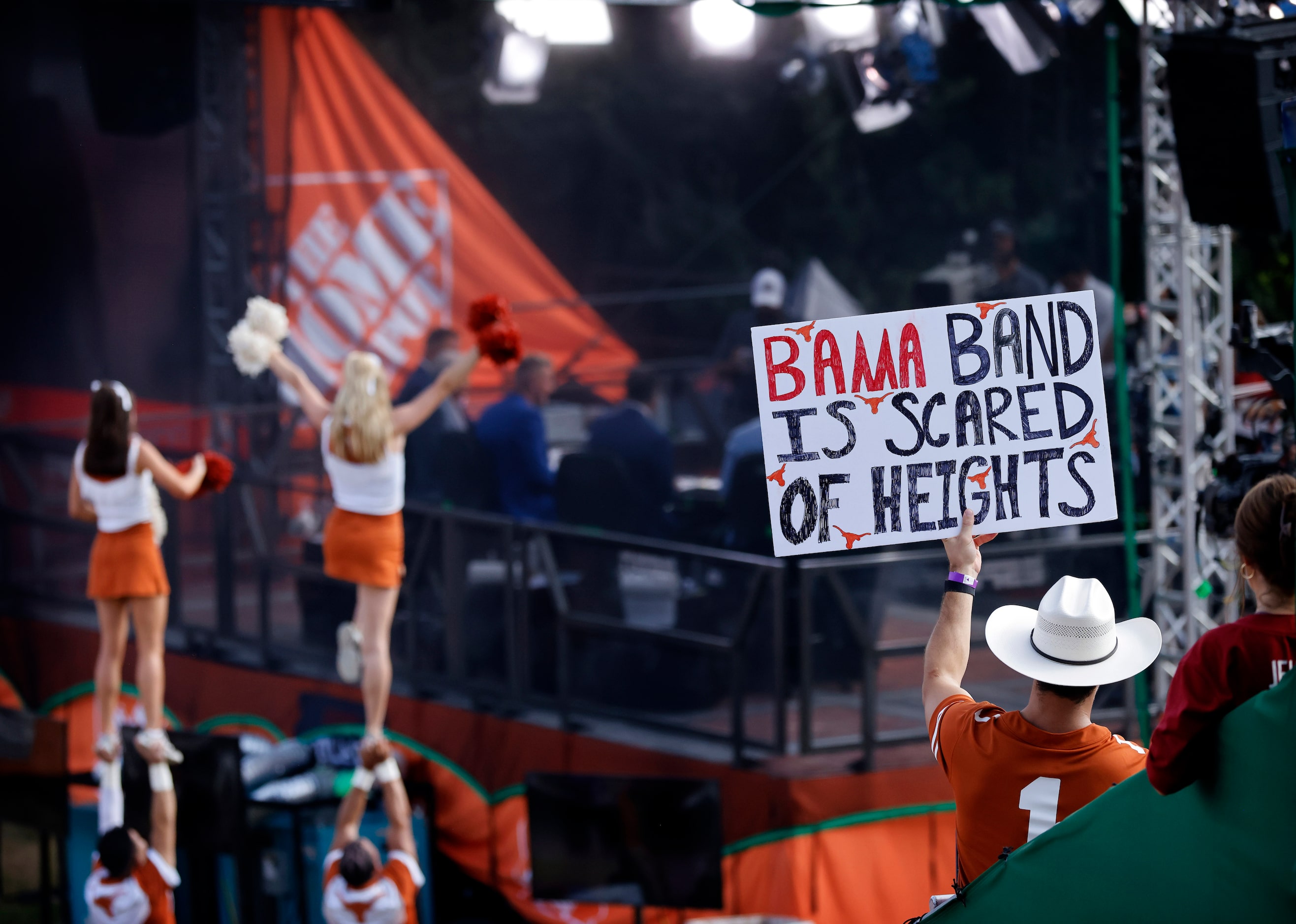 A Texas Longhorns fan flashes a sign behind ESPN’s College GameDay outside Darrell K....