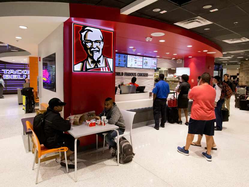Customers lined up at a Kentucky Fried Chicken restaurant inside Miami International Airport...