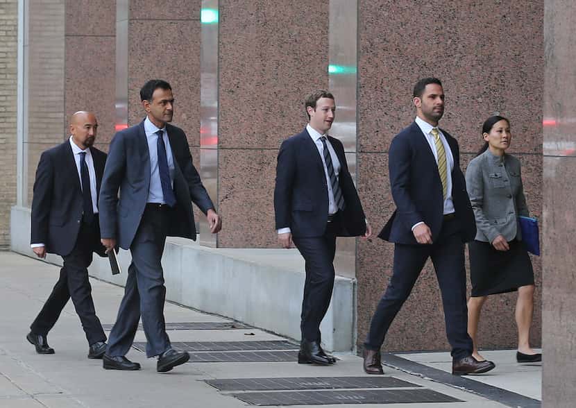 Facebook CEO Mark Zuckerberg arrives with his entourage at the Earl Cabell Courthouse in...