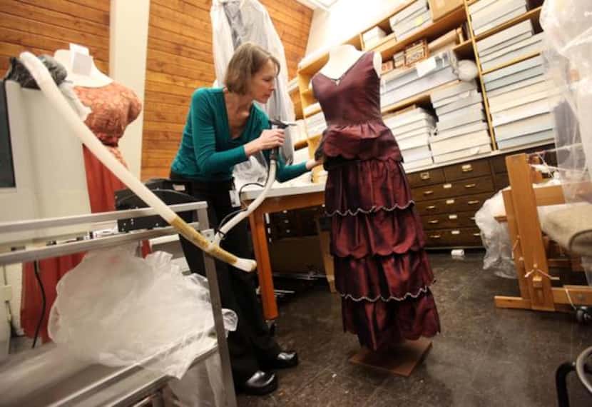
Kate Sahmel, a textile conservator, steams the engagement dress of character Mary worn in...
