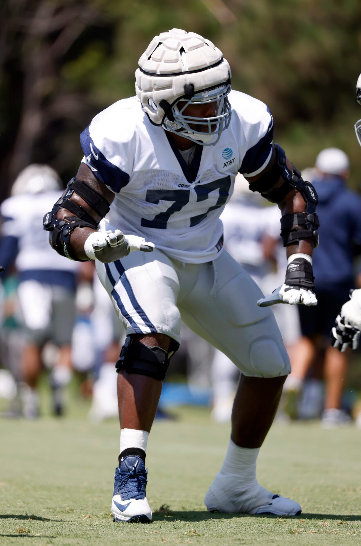 With all his braces on, Dallas Cowboys offensive tackle Tyron Smith (77) runs a drills...