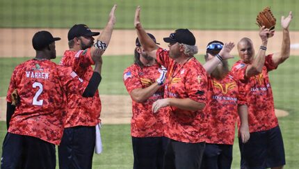 Musician Toby Keith joins teammates during player introductions before the Red River...