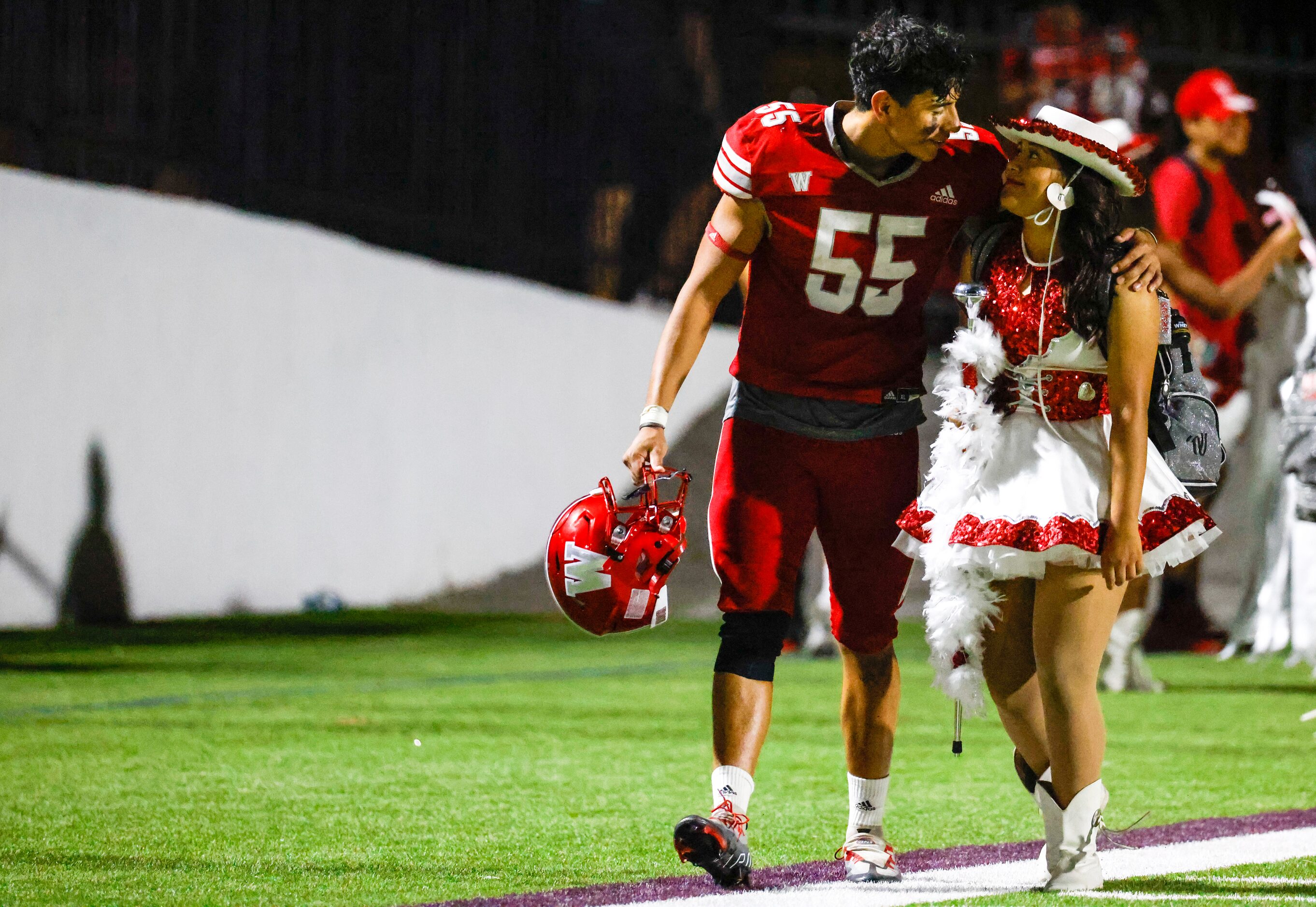 Woodrow Wilson defensive line Ivan Gonzalez (55) walks with Lesli Aguilar after a win...