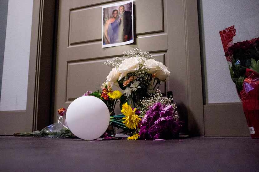 The front door of Botham Shem Jean's apartment has become the site of a small memorial.