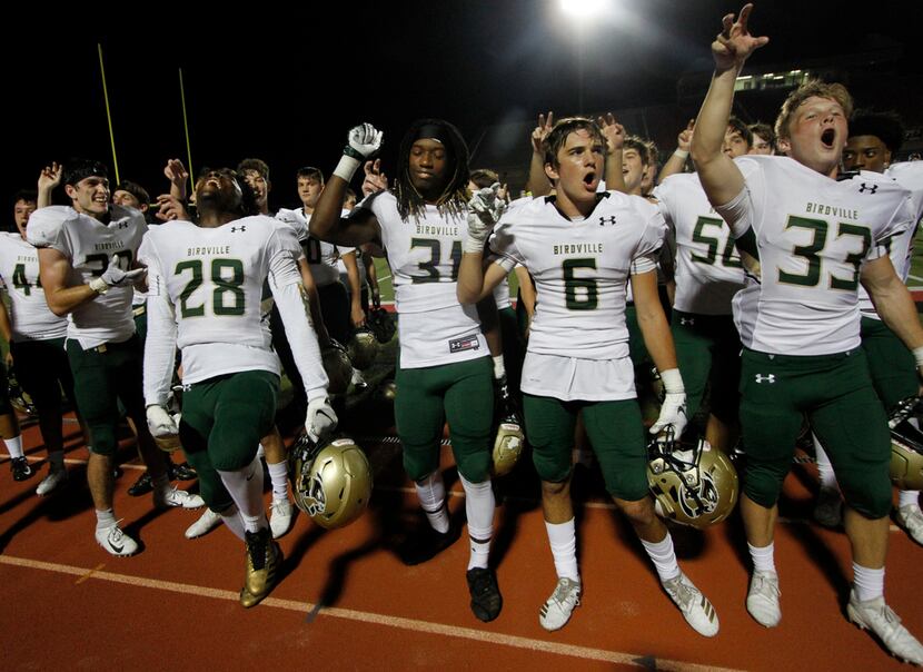 Birdville players celebrate as their band plays the alma mater following their 24-20 victory...