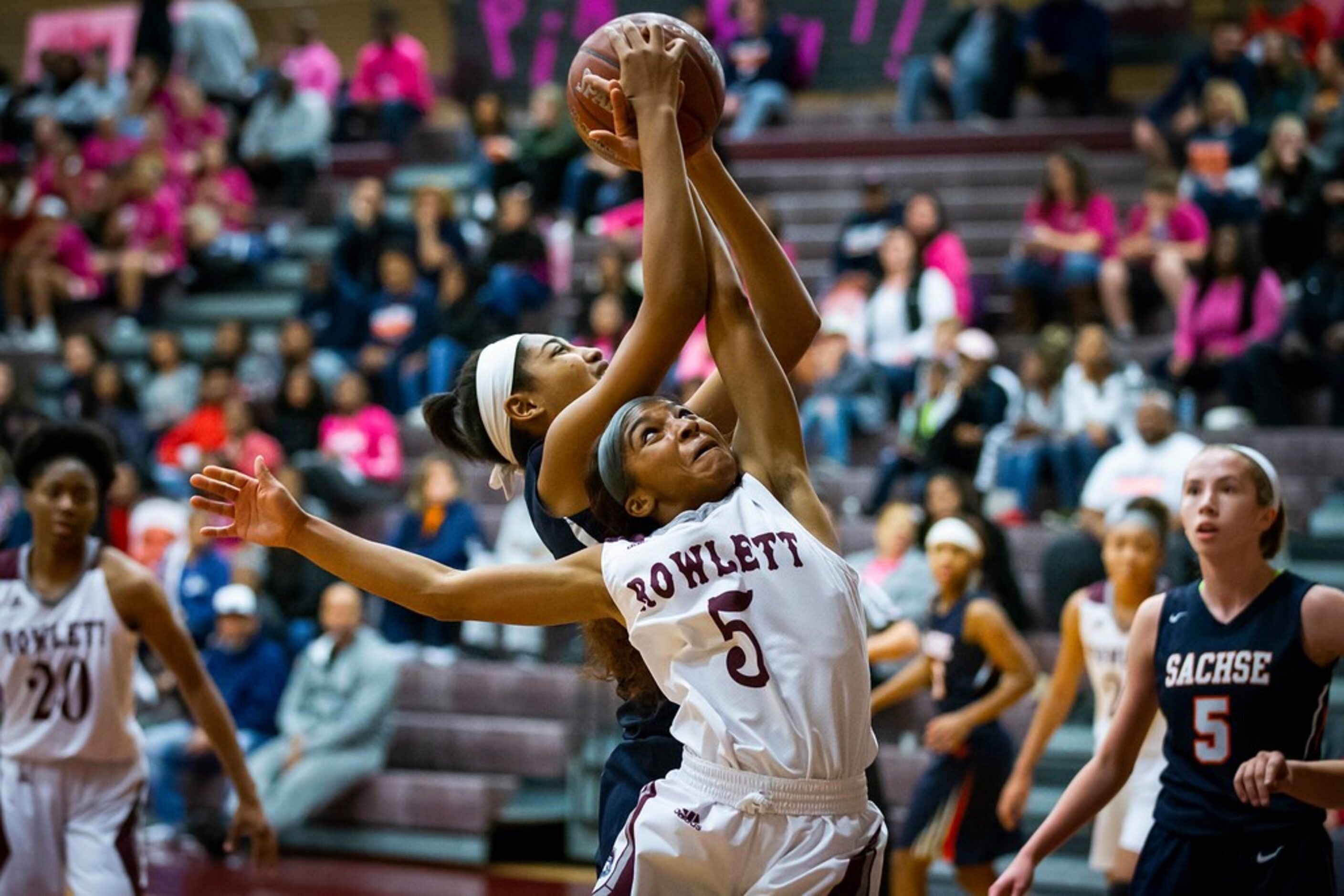 Rowlett guard Deja Duncan (5) fights for a rebound against Sachse center Elizabeth Woods...