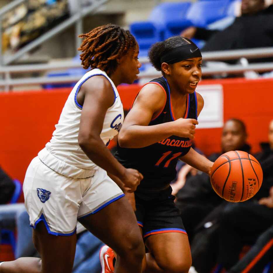 Duncanville Pantherettes' Tristen Taylor (11) dribbles the basketball against Conway Lady...