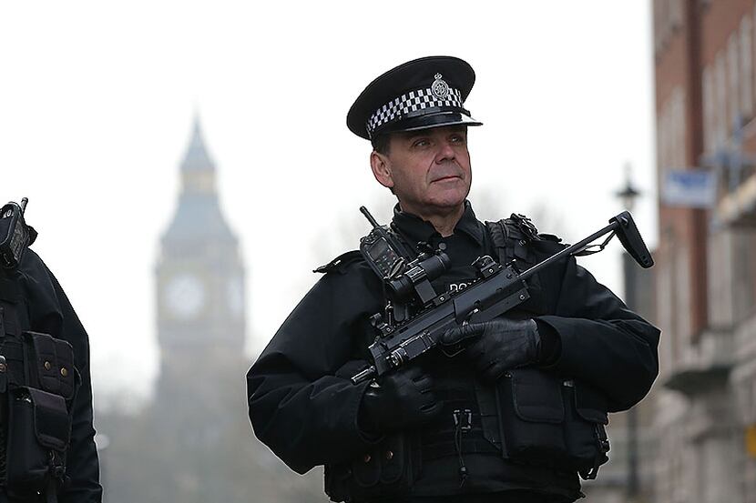Armed police officers secure the area near the Houses of Parliament Thursday in central...