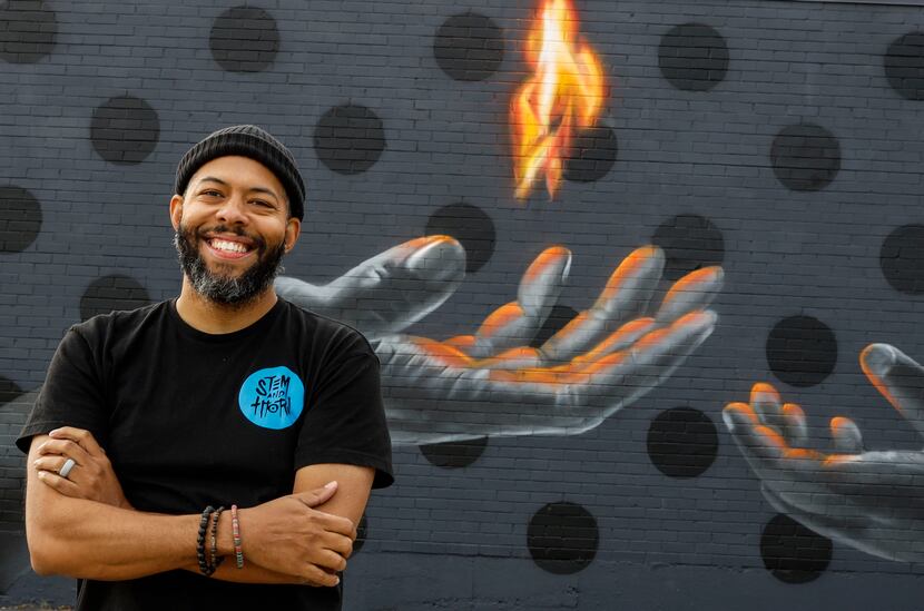 Jeremy Biggers posed for a portrait in front of his mural "Legacy" in Dallas on Nov. 18,...