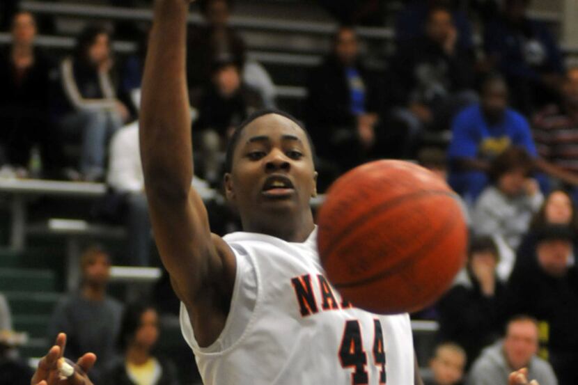 Garland Naaman Forest's Prince Ibeh slaps a rebound away from Garland Lakeview's Toddrick...