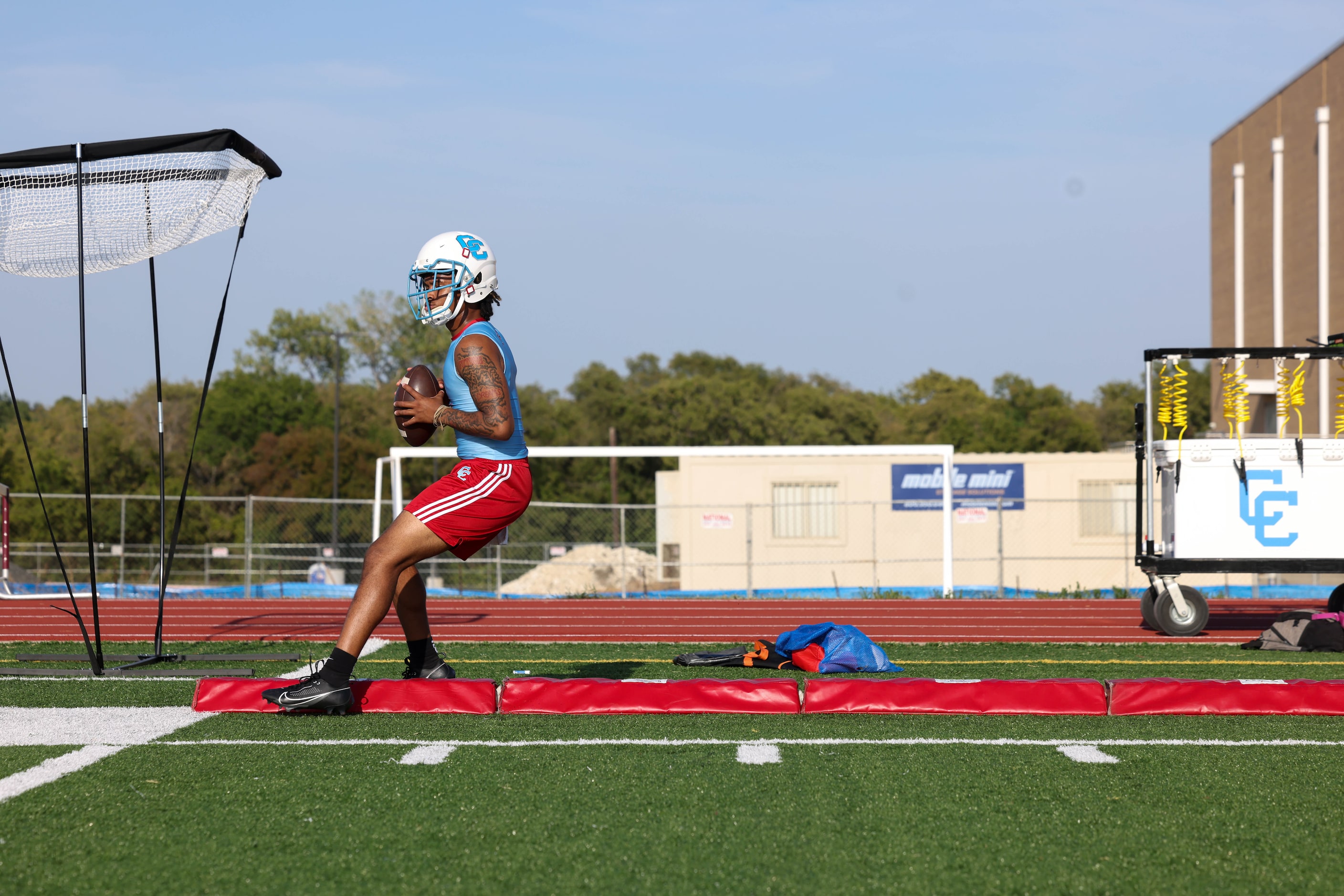 Quarterback Quay Robinson takes part in a drill during the first practice of the season at...