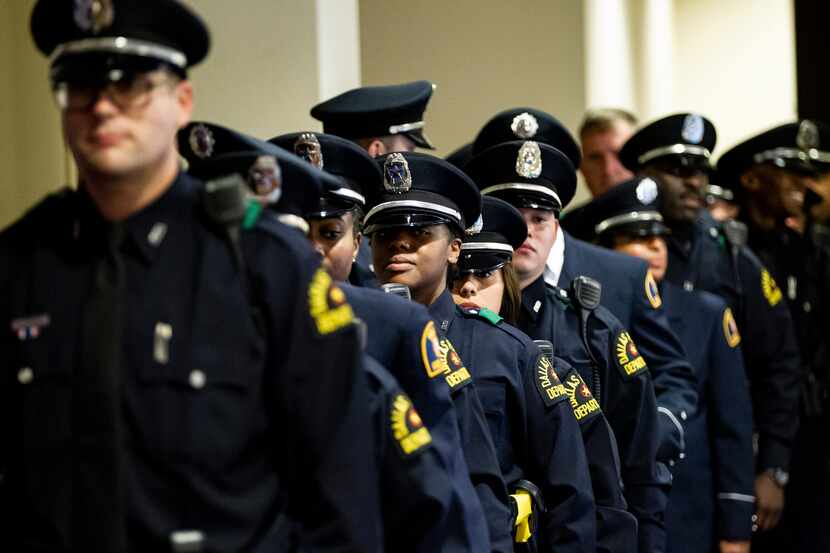 Members of the Dallas Police Academy Class #366 wait to enter their graduation ceremony at...