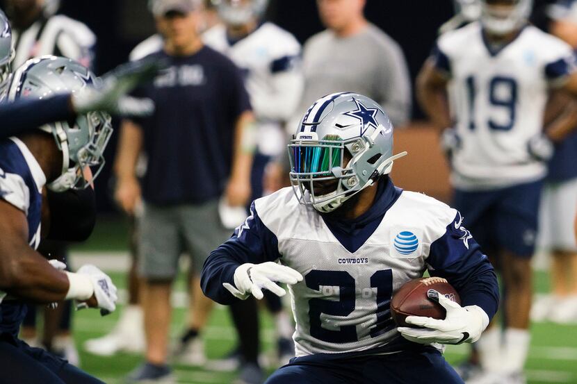 Dallas Cowboys running back Ezekiel Elliott (21) runs the ball during a team OTA practice at...