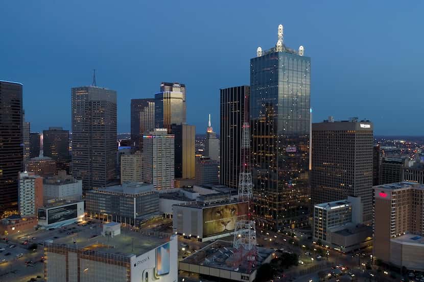 Downtown Dallas' 56-story Renaissance Tower with its lighted towers on the roof is one of...