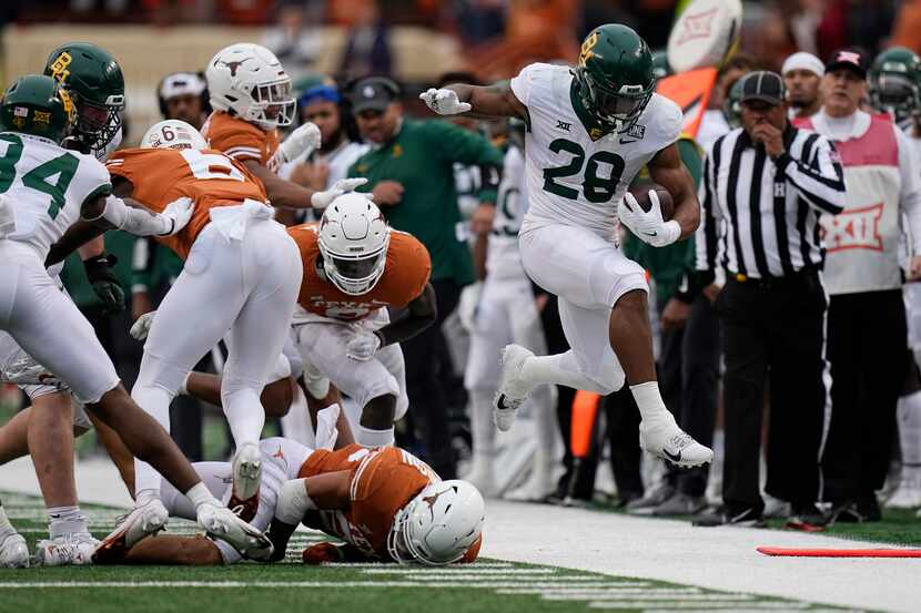 Baylor running back Qualan Jones (28) runs for a first down against Texas during the second...