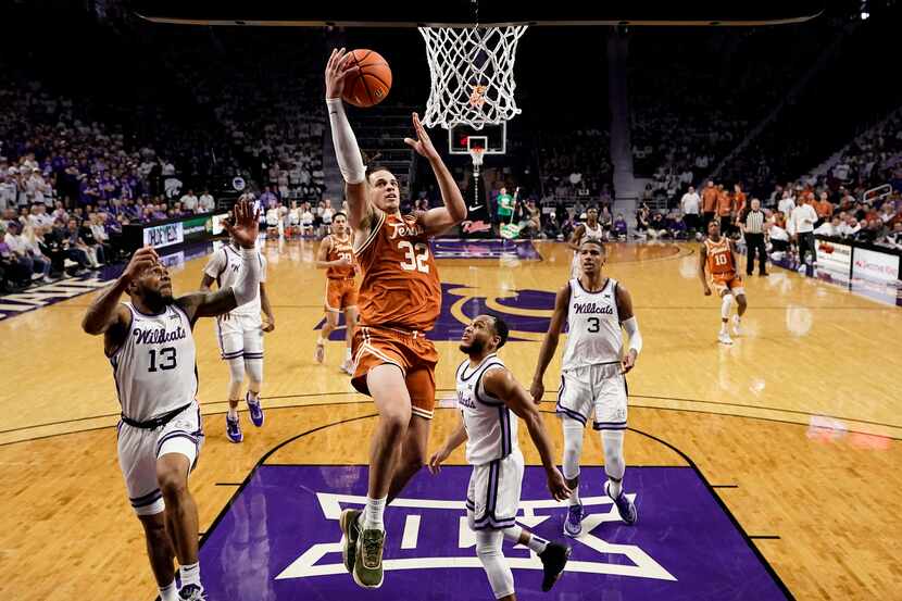 Texas forward Christian Bishop (32) puts up a shot during the first half of an NCAA college...