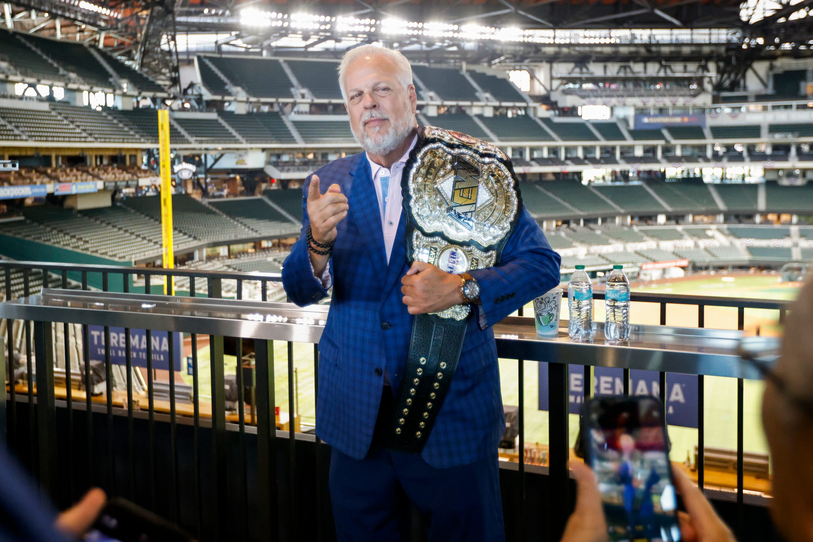 Arlington mayor Jim Ross poses with an AEW championship belt after the announcement of a...