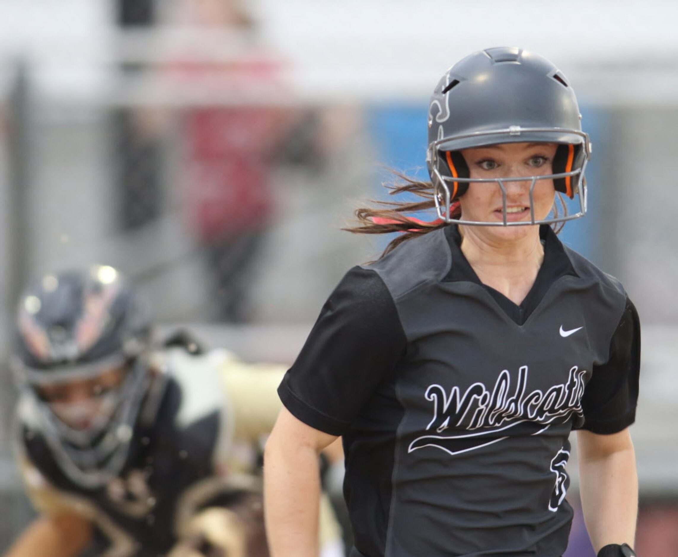 Denton Guyer's Lauren Lindgren (6) beats out a bunt to reach first base safely during the...