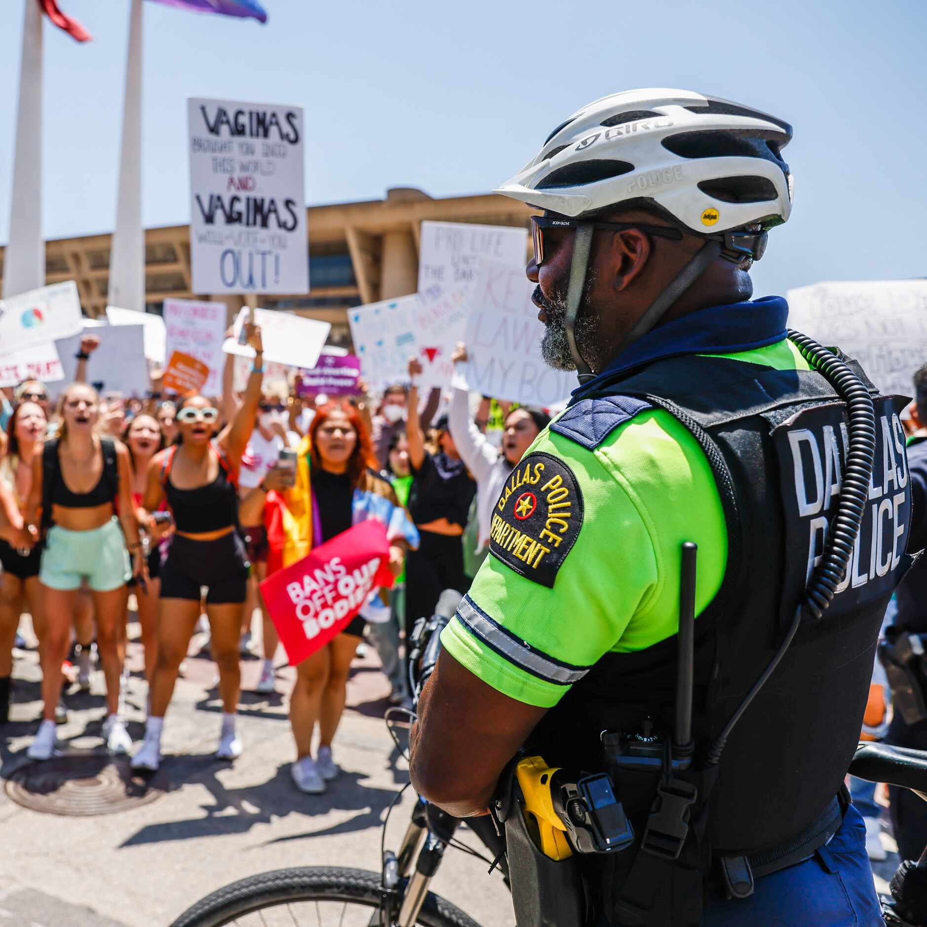 A Dallas Police officer tries to contain Abortion rights supporters so that they don't march...