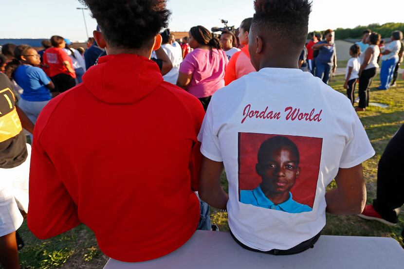 Alandre Henderson (right) wears a shirt in memory of Jordan Edwards during a vigil at Gentry...