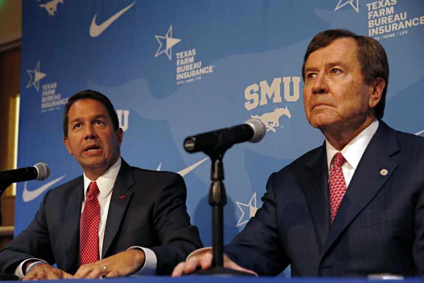 Rick Hart (left), director of athletics for Southern Methodist University, addresses the...