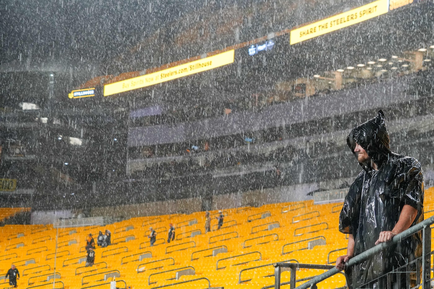 While most fans heed stadium officials’ calls to move under covers a few brave the elements...