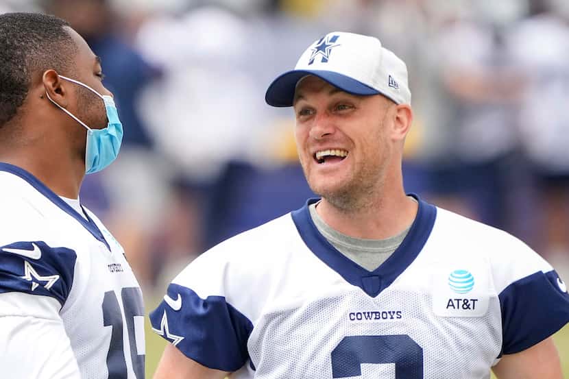 Dallas Cowboys wide receiver Amari Cooper talks with kicker Greg Zuerlein (2) on the...