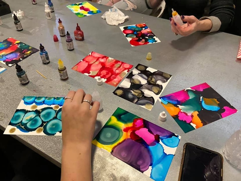 Clients at The Art Lounge experiment with alcohol ink paints on Oct. 20, 2020. (Courtesy The...