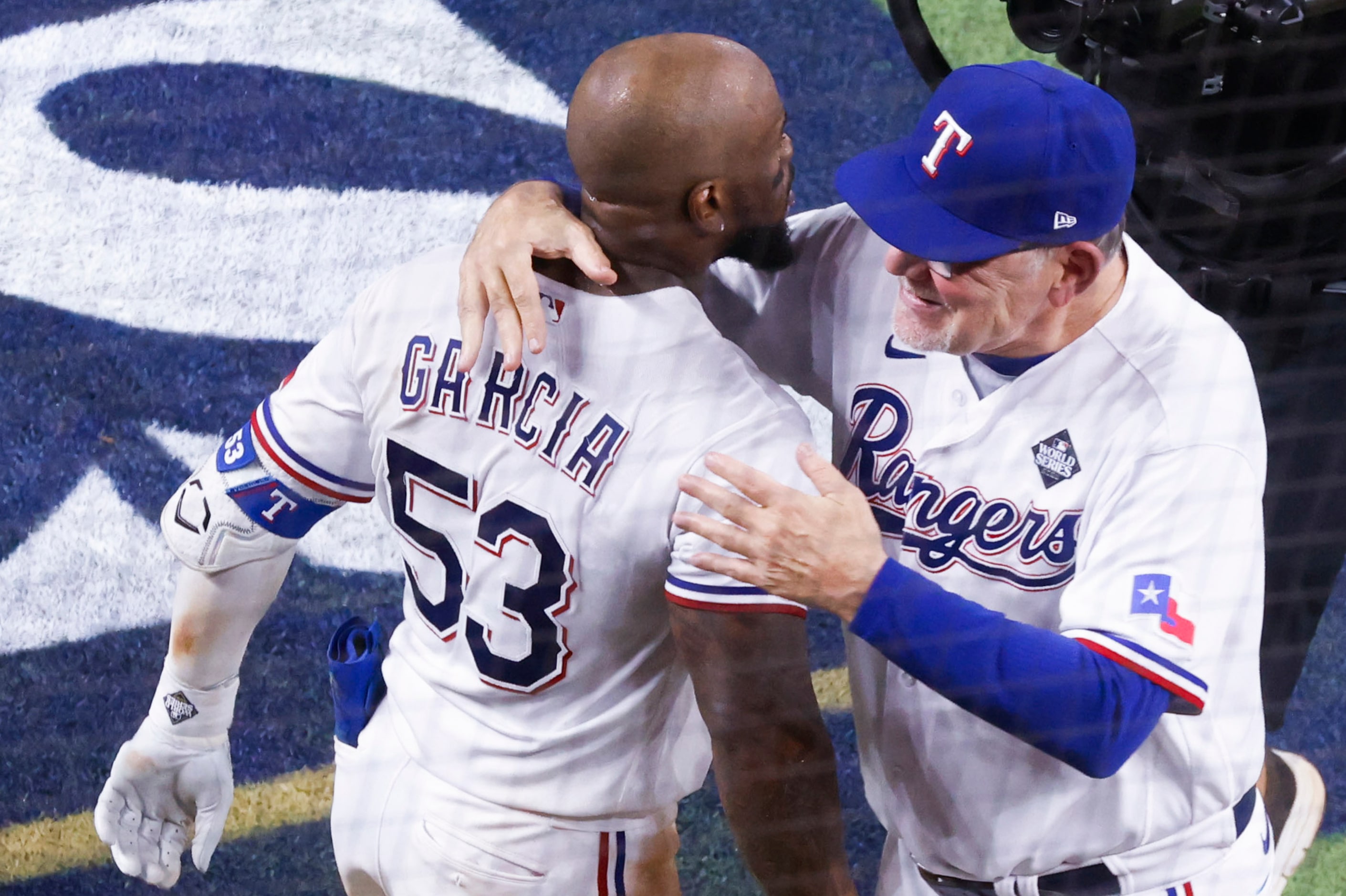 Texas Rangers right fielder Adolis Garcia (left) celebrates with manager Bruce Bochy after...