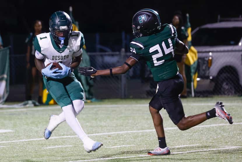 DeSoto High School’s Johntay Cook II (1) completes a touchdown past Lake Ridge High School’s...
