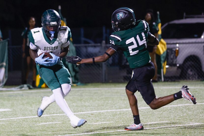 DeSoto High School’s Johntay Cook II (1) completes a touchdown past Lake Ridge High School’s...