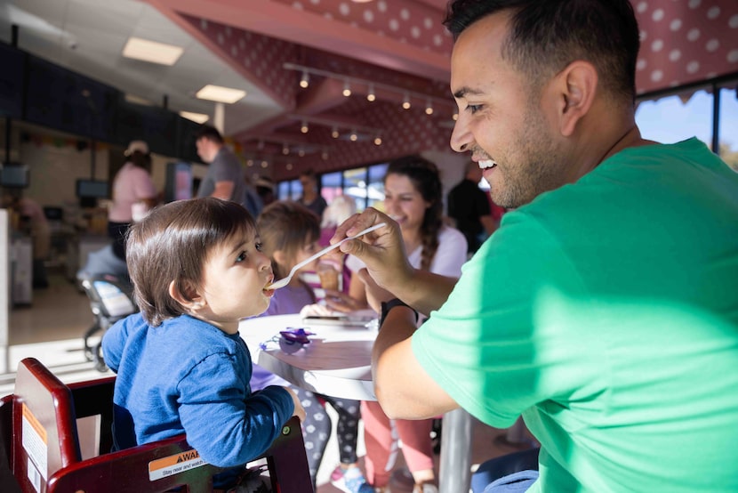 Robert Torrez of Colleyville and 11-month-old son Leonardo share the Cosmic Birthday Cone at...