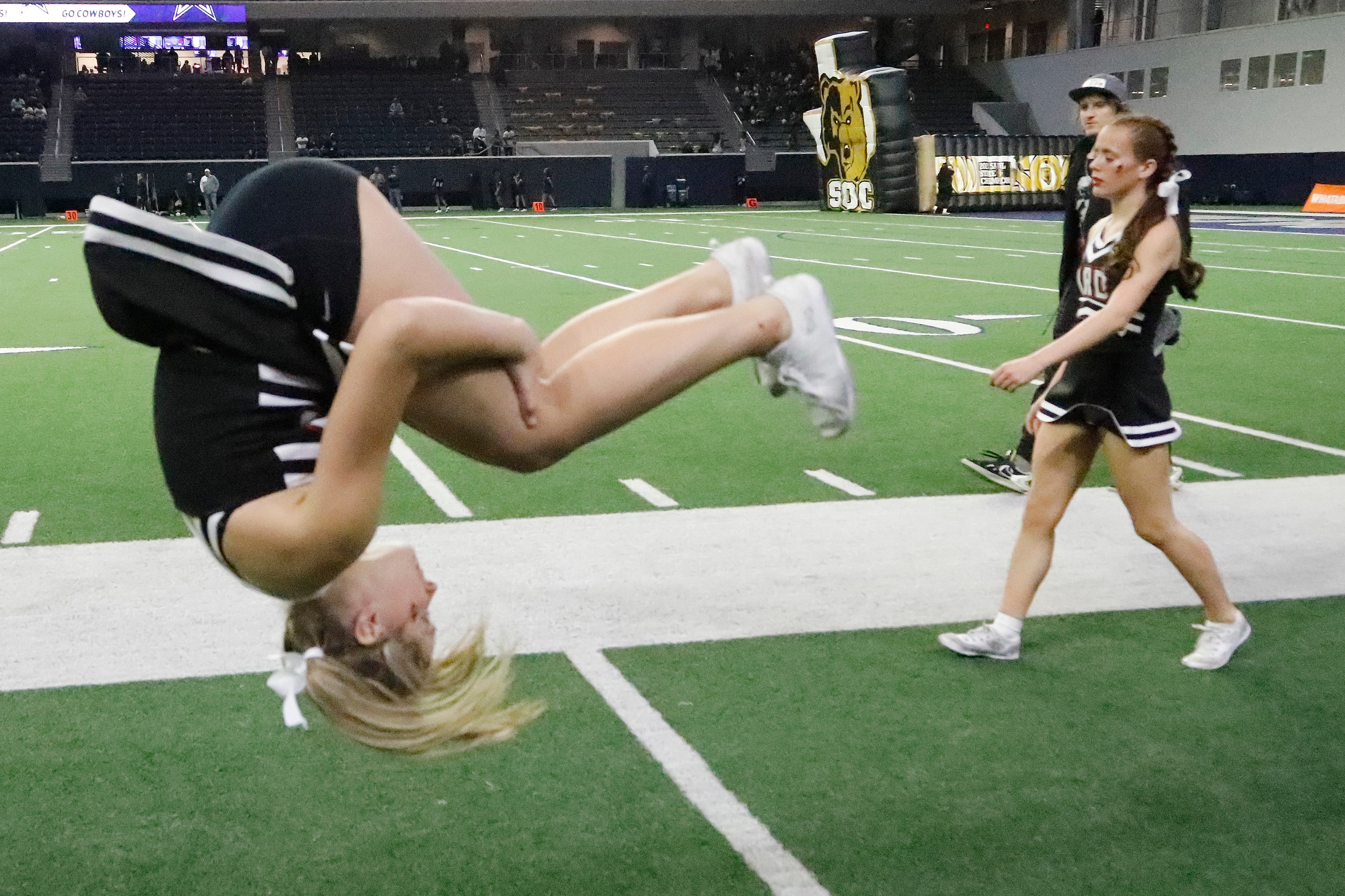 Melissa cheerleader Kennedy Gentry (left), 16, warms up as cheerl team mate Madison Herrin,...