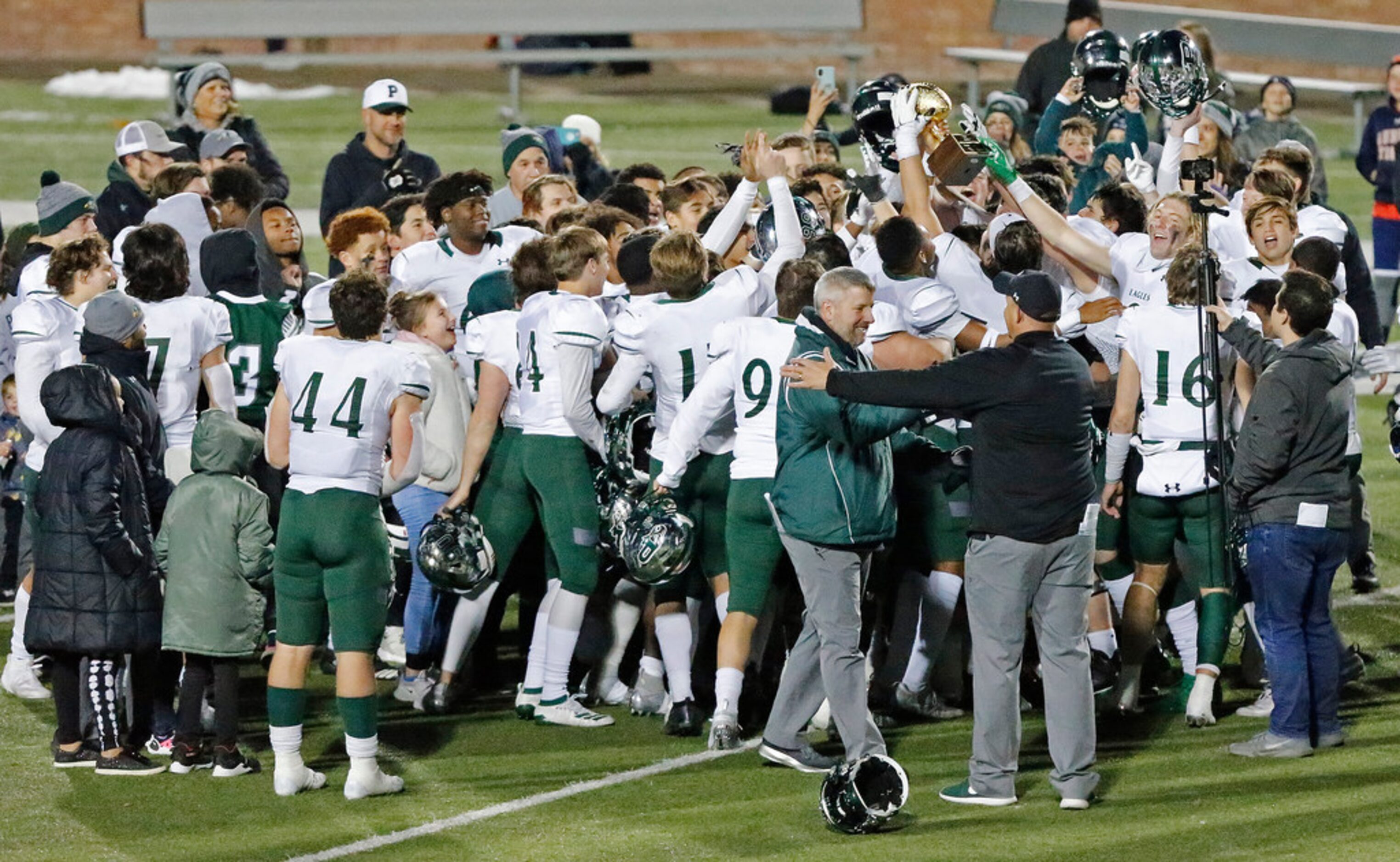 Prosper High School hoist their area trophy after defeating Mesquite High School in a Class...