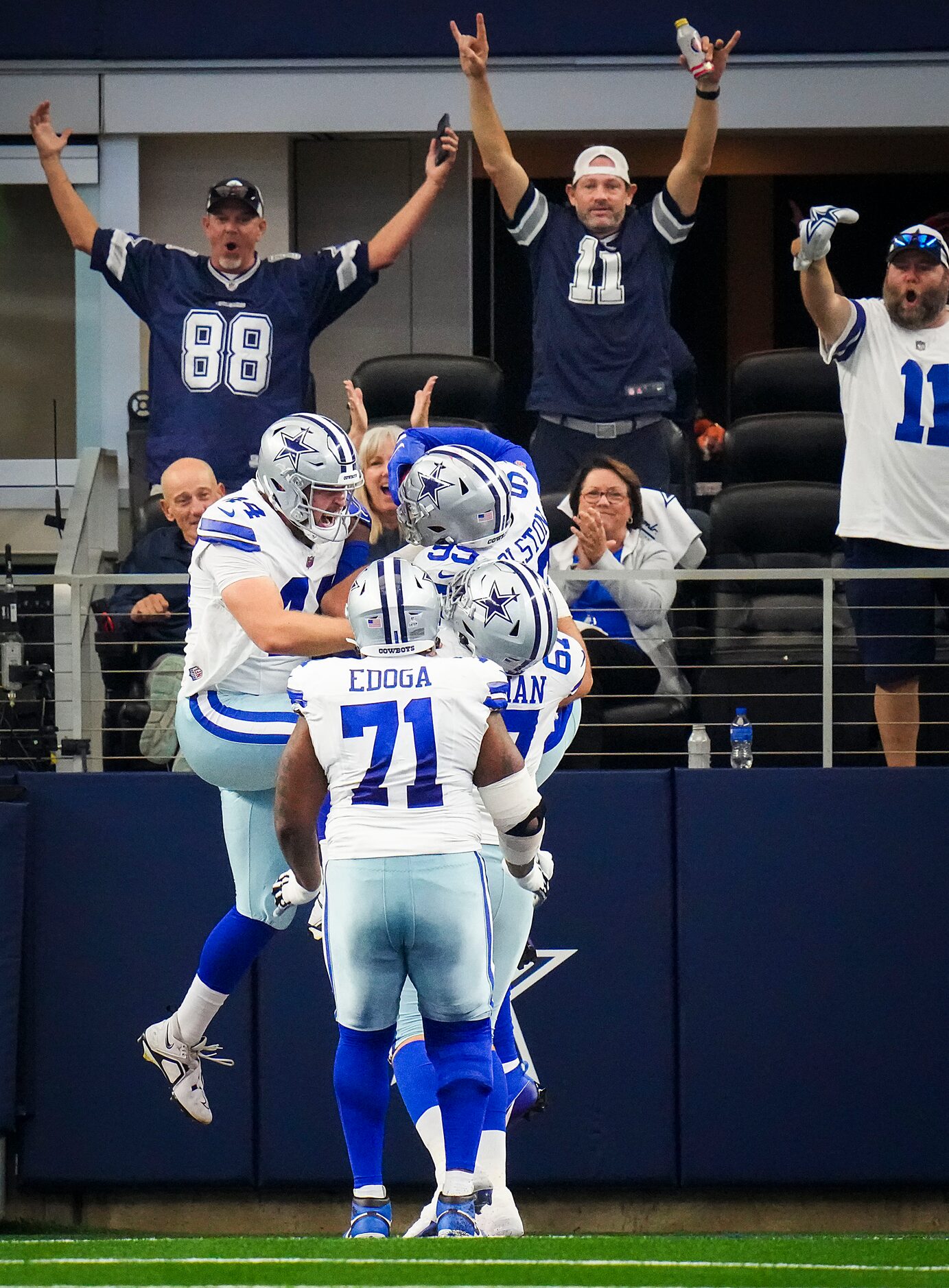 Dallas Cowboys defensive end Chauncey Golston (99) celebrates with teammates, including long...