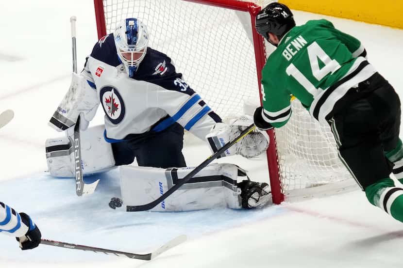 Winnipeg Jets goaltender Laurent Brossoit (39) stops Dallas Stars left wing Jamie Benn (14)...
