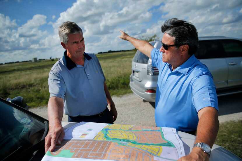 Northstar developers Kim Gill (right) and Tim Fleet look over plans for another development,...