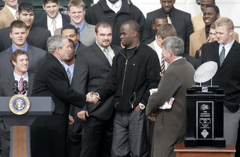 President Bush, left, reaches out to shakes hands with University of Texas Quarterback Vince...