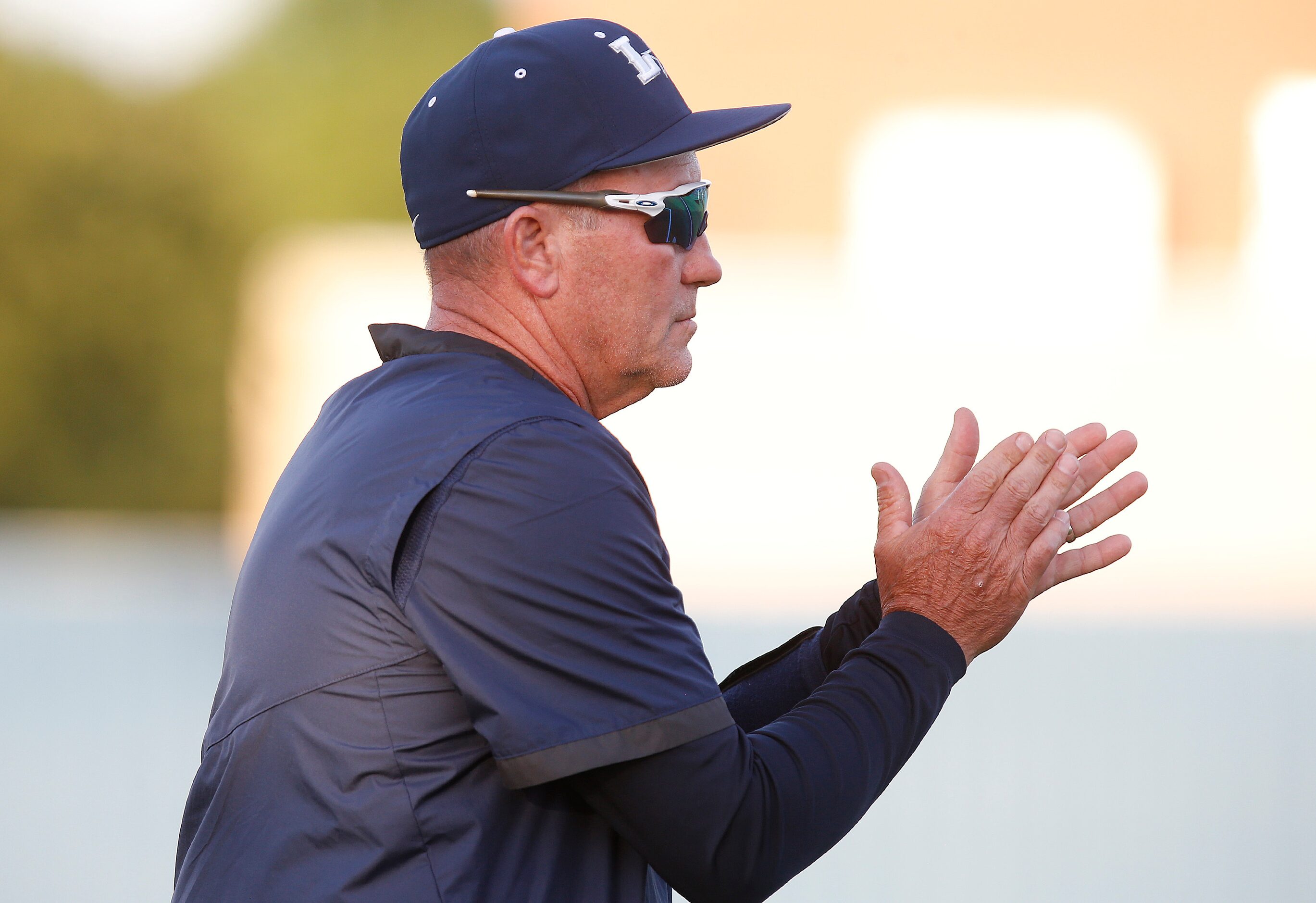 Lone Star High School head coach Joey Franke applauds his team in the second inning as Lone...