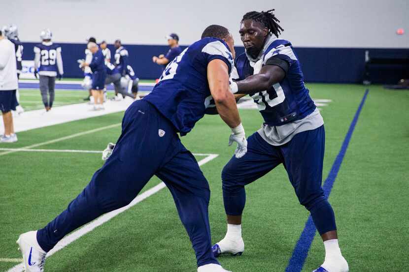 Dallas Cowboys defensive end Demarcus Lawrence (90) takes on defensive tackle Tyrone...
