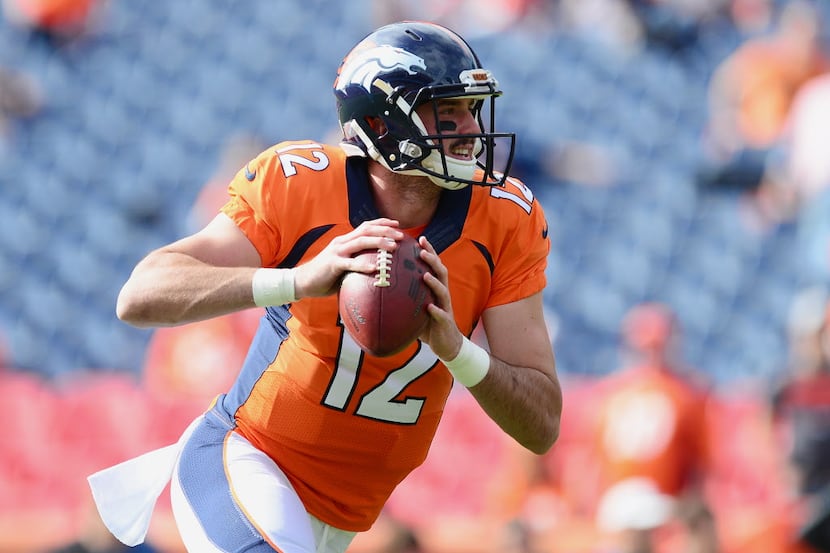 DENVER, CO - OCTOBER 30:  Quarterback Paxton Lynch #12 of the Denver Broncos warms up before...