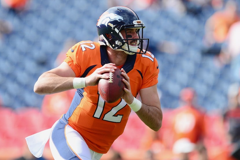 DENVER, CO - OCTOBER 30:  Quarterback Paxton Lynch #12 of the Denver Broncos warms up before...