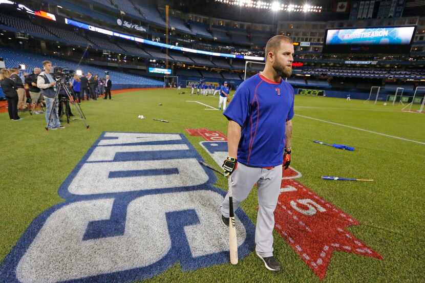 Texas Rangers first baseman Mike Napoli (25) walks across the ALDS logo after taking batting...